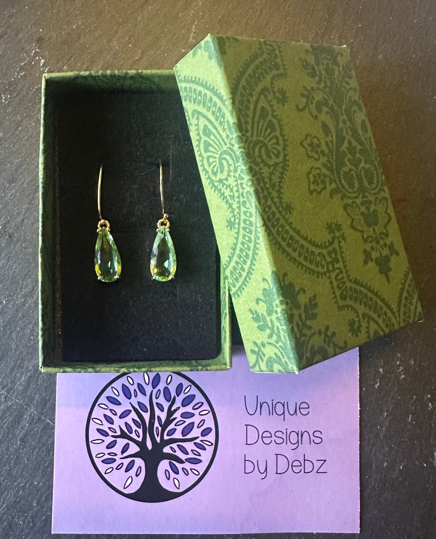 Green faceted teardrop earrings on gold plated hoops