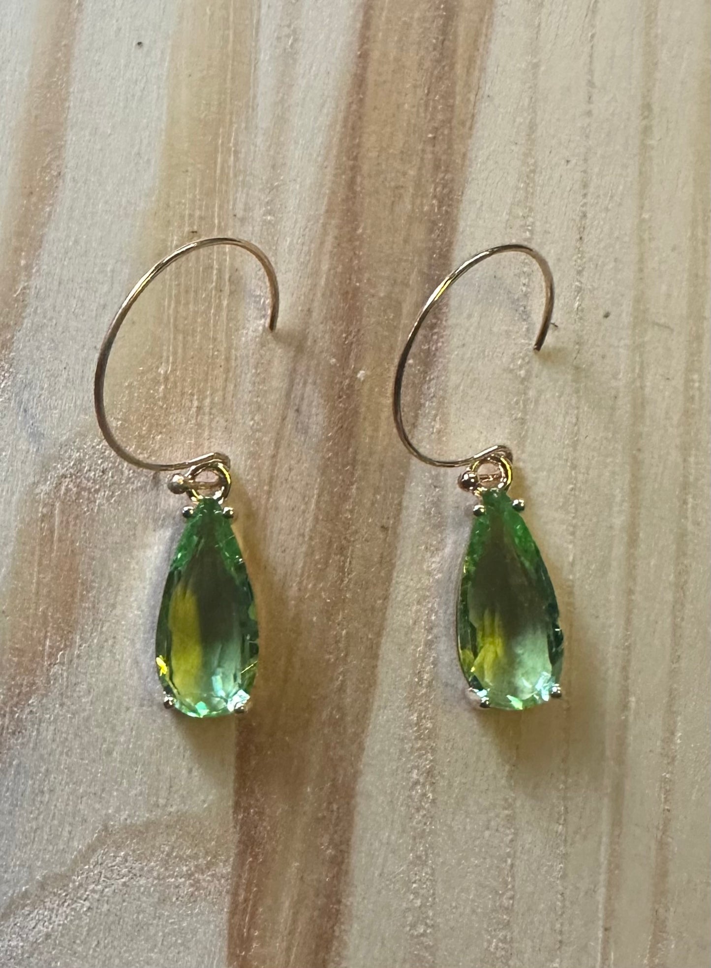 Green faceted teardrop earrings on gold plated hoops