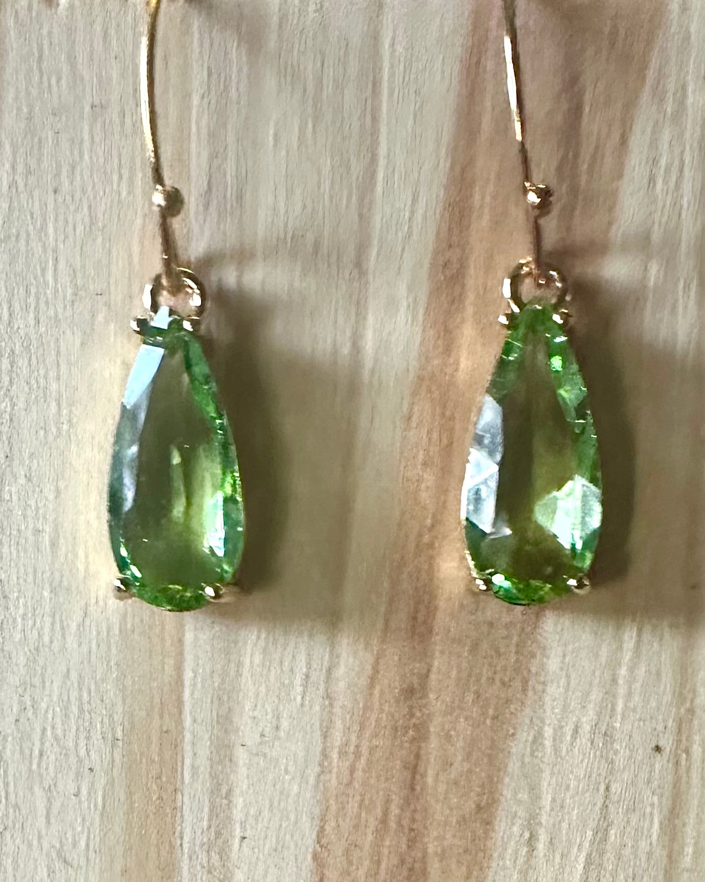 Green faceted teardrop earrings on gold plated hoops